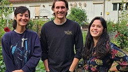 Three students standing at the UO Urban Farm