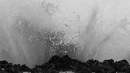 Black and white photo of a wave crashing