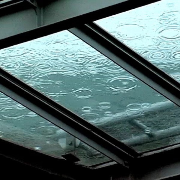 raindrops fall on glass ceiling